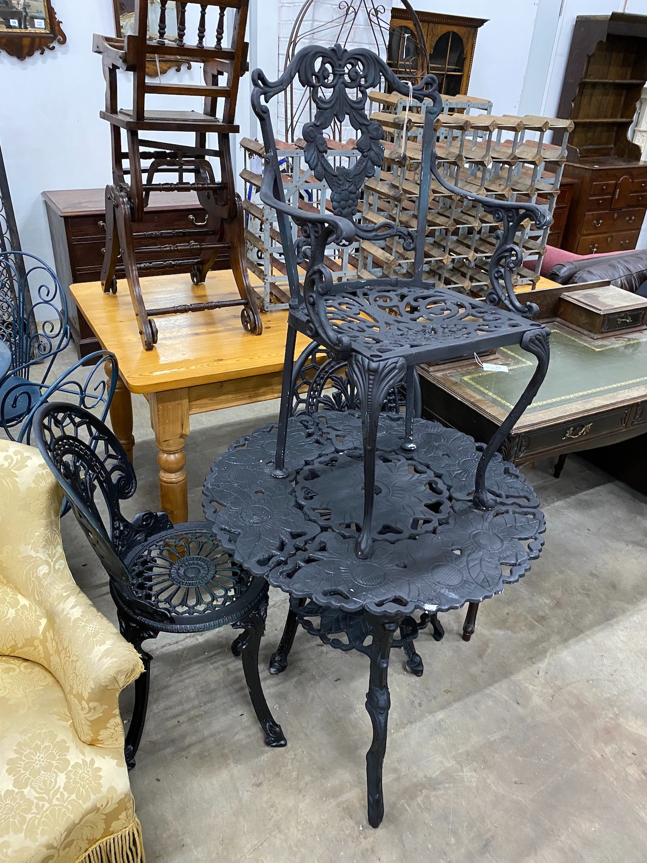 A circular aluminium garden table, diameter 76cm, height 70cm and three aluminium garden chairs
